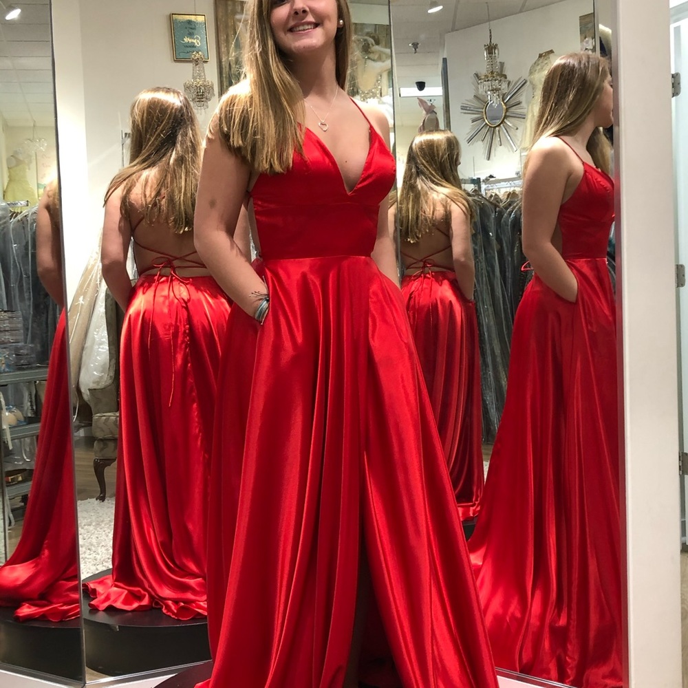 Beautiful Red Prom Dress. New with tags. Crisscross back straps. Pockets